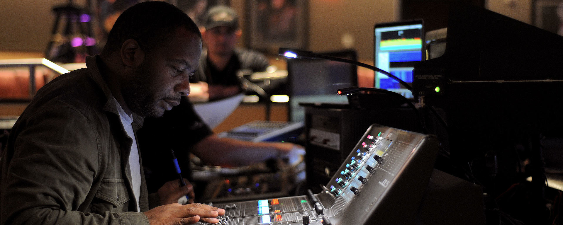 This image shows Schon Emmanuel in studio on his mixing console
