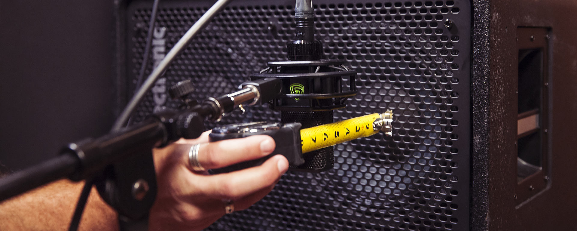 LEWITT microphone is getting positioned in front of bass amp